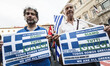Demonstrators hold banners reading 'We are all Greeks' as they take part in a rally to sup...