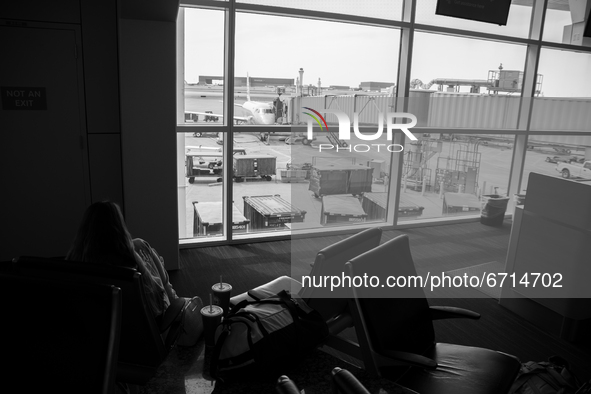 A passenger waits to board their next flight at Dallas-Fort Worth International Airport on April 12, 2021. As America’s COVID-19 vaccination...