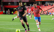 Marco Asensio of Real Madrid in action with Quini of Granada CF during La Liga match betwe...