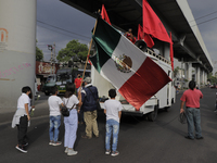 Children from the Francisco Villa Independent Popular Front march holding a Mexican flag on Avenida Tláhuac to demand justice for the 26 peo...