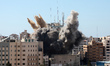 A thick column of smoke rises from the Jala Tower as it is destroyed in an Israeli airstri...