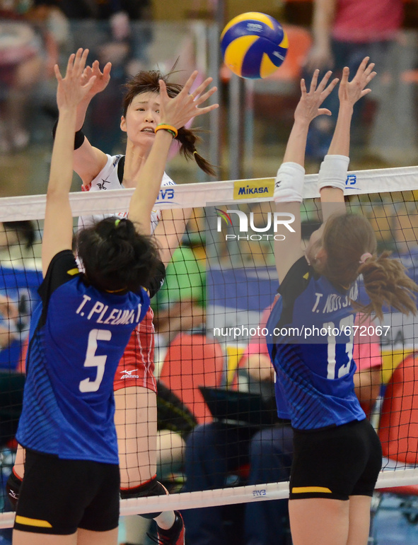 Saori Kimura (Top) of Japan spikes the ball as Thailand players attemp to block during their FIVB World Grand Prix intercontinental round ma...