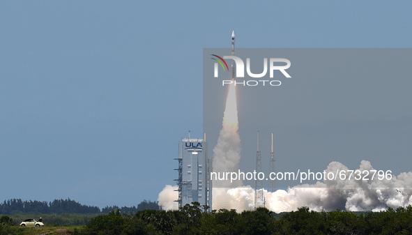 A man stands by his car as he watches the launch of a United Launch Alliance Atlas V rocket carrying the fifth Space Based Infrared System G...