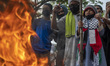 Protesters burn Israeli flags while participating in a solidarity action for Palestinians...