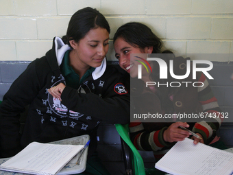 Two teenage women from a primary school in Mexico take classes during the back-to-school period to continue their studies in Mexico City, Me...