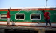 Railway worker seen cleaning and washing a train at Komlapur railway station as the train...