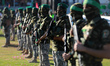Militants stand guard around the stage as Yahya Sinwar, the Palestinian leader of Hamas in...
