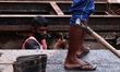 Municipality workers cleaning drains of Guwahati city ahead of flood season, in Guwahati,...