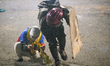 People cover themselves with shields from the police attacks on May 26, 2021 in Bogotá, Co...