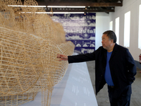 Chinese artist Ai Weiwei touches one of his artworks during a press preview of his new exhibition 'Rapture'  at the Cordoaria Nacional in Li...