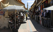 A Turkish Cypriot man sells clothes on a shopping street in Turkish-occupied territory in...