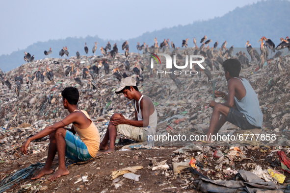 Ragpicker sitting next to a garbage-heap at Boragaon dumping site, on the eve of World Environment Day, in Guwahati, Assam, India on Friday,...
