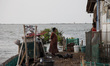 Villagers do their activity in their neighborhood surrounded by tidal floods in Bandengan...