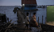 Villagers do their activity in their neighborhood surrounded by tidal floods in Bandengan...