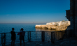 People looking out from the balcony overlooking the cliffs of Polignano a Mare on June 4,...