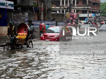 Vehicles try to driving through the waterlogged streets a waterlogged street after a heavy downpour in Dhaka, Bangladesh, on June 5, 2021. A...