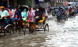 Vehicles try to driving through the waterlogged streets a waterlogged street after a heavy...