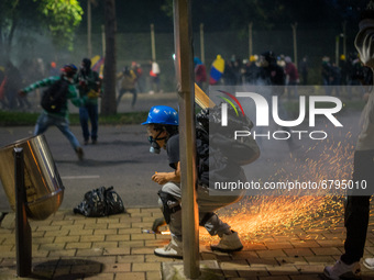 Riot police clash with demonstrators during a protest against the government of Colombian President Ivan Duque in Medellin, Colombia on June...