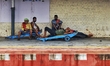 Coolies take rest on an empty railway platform amid coronavirus emergency in Kolkata, Indi...