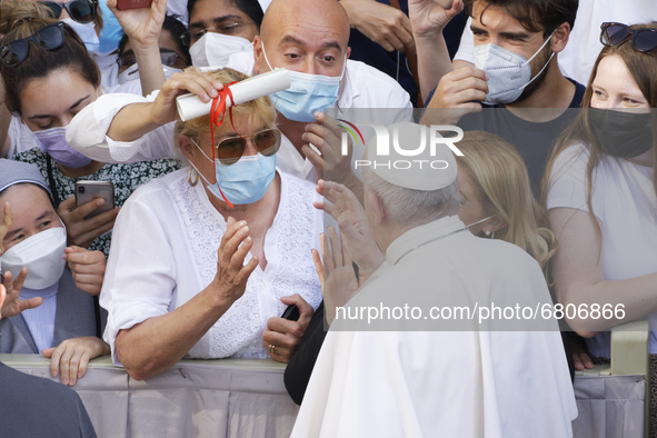 Pope Francis greets faithful as he arrives for his weekly open-air general audience in the St. Damasus courtyard at The Vatican, Wednesday,...
