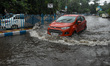 Cars tries to make their way through a flooded road in Kolkata, India on 17 June 2021. Kol...