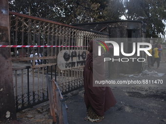 A woman covered in hijab stand at the entrance of Ogun State Property and Investment Corporation Plaza, after a gasoline explosion in distri...