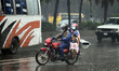 Motorists make their way during the rain at Manik mia avenue street in Dhaka, Bangladesh o...