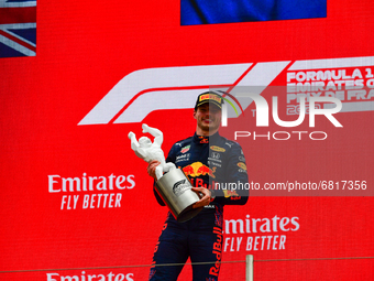Winner Red Bull's Dutch driver Max Verstappen celebrates with the trophy on the podium at the end of the French Formula One Grand Prix at th...