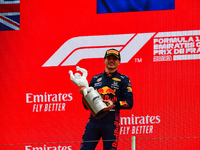 Winner Red Bull's Dutch driver Max Verstappen celebrates with the trophy on the podium at the end of the French Formula One Grand Prix at th...