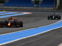 Max Verstappen of Red Bull Racing Honda drive his RB16B single-seater and Lewis Hamilton of Mercedes-AMG Petronas F1 Team drive his W12 sing...