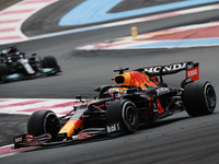 Max Verstappen of Netherlands driving the (33) Red Bull Racing RB16B Honda and Lewis Hamilton of Great Britain driving the (44) Mercedes AMG...