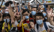 Passengers riding on the first train of the Tuen Ma Line in Hong Kong, Sunday, June 26, 20...