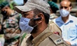 A JKP Jammu and Kashmir Police Cop wearing a mask during Indian Army's Event in Baramulla,...