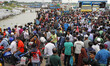 People board an overcrowded ferry as they go home a day before a countrywide lockdown is i...