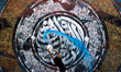 Palestinian artist Bilal Khaled draws on a wall ordinate in Gaza city on July 1, 2021. "Gr...