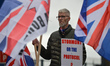 A Loyalist holds a placard with words 'Stormont Or The Protocol?' during a protest against...