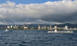 Tugboat towing a submarine in the South Pacific Ocean, Hawaii, USA. In the background buil...