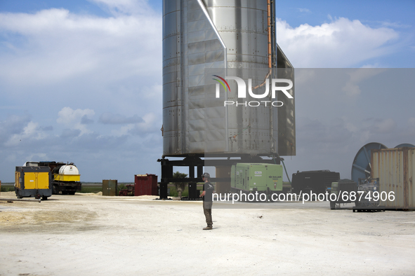 A SpaceX employee stands next to Starship SN15 on July 13th, 2021 in Boca Chica, Texas.  