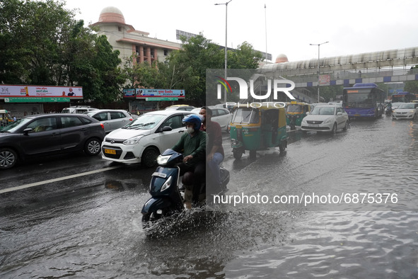 A motorist drives past a flooded street after heavy rains in New Delhi, India on July 14, 2021. The monsoon rain provided some relief to res...