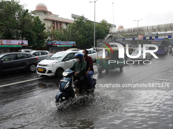 A motorist drives past a flooded street after heavy rains in New Delhi, India on July 14, 2021. The monsoon rain provided some relief to res...