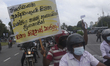 Union members and Civil Activists hold placards during a protest against the controversial...