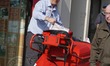 Postman on his round delivering letters & parcels using a "high capacity" trolley in Worth...