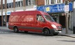 Royal Mail Parcel force postal van outside shops in high street Worthing West Sussex UK