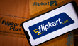 Flipkart logo displayed on a phone screen and Flipkart website displayed on a laptop scree...