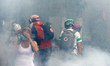 First helpers amid clouds of tear gas. More than 10,000  protesters took to the streets in...
