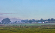 Smoke from nearby burning crops shrouds farmland in the La Romana Province in the Dominica...