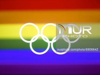 Olympic rings symbol is photographed with LGBT+ rainbow flag in the background in this multiple exposure illustration photo taken in Leszcze...