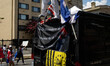 A man stands on top of a vehicle as thousands of demonstrators march from the White House...