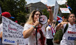 Demonstrators yell at bystanders during a march from the White House to the Cuban Embassy...