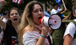 Demonstrators yell at bystanders during a march from the White House to the Cuban Embassy...